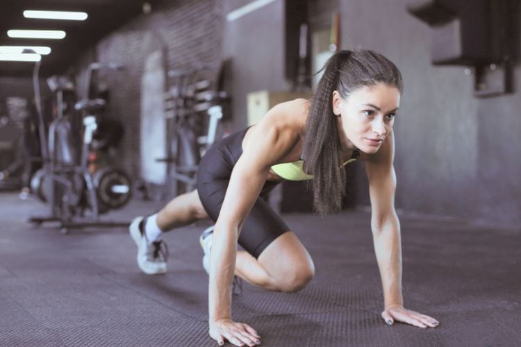 Woman performing jump squats in a full body 10 minute workout