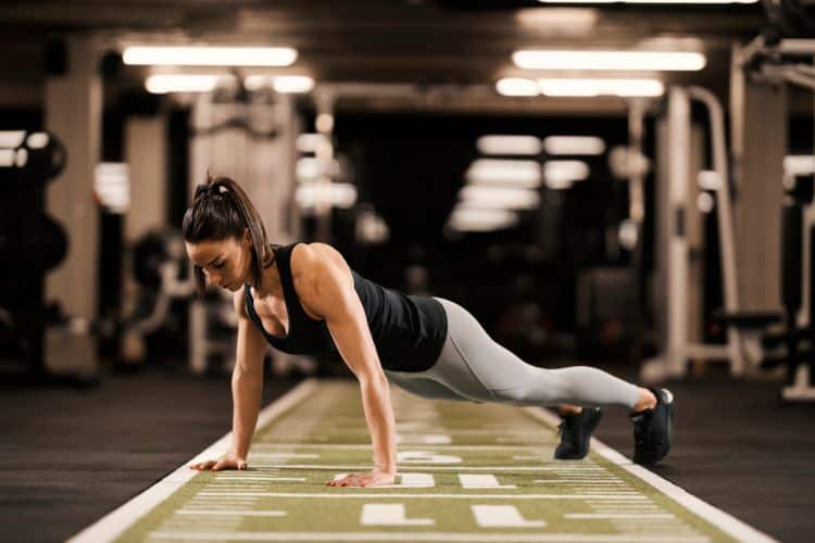 Woman doing jump squats during a 10-minute full body HIIT workout