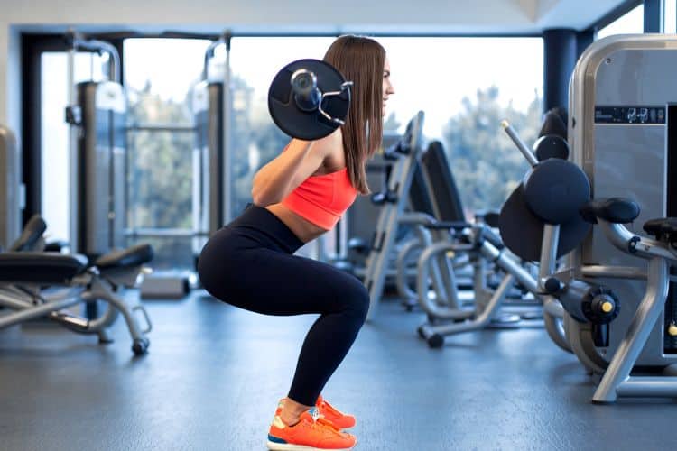 Woman doing squats during a 15-minute lower body workout