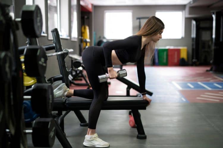 Woman performing dumbbell squat press in a 15 minute full body workout