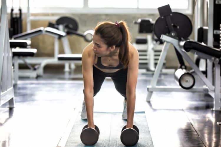 Woman performing push-ups during a 15 minute upper body HIIT workout