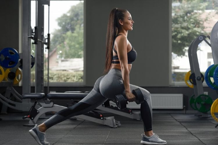 Woman performing squat jumps during a 20-minute lower body workout