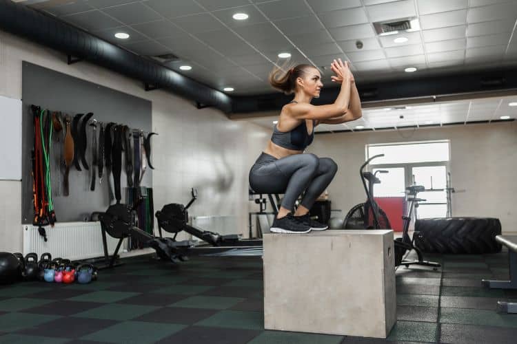 Woman doing jump squats in a 30-minute fat-burning cardio workout