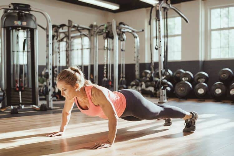 Woman performing squats during a 30 minute full body workout