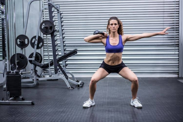 Woman doing squat to press a 40-minute full body circuit workout