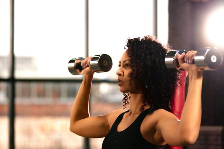 Woman performing dumbbell squats during a 40 minute full body workout