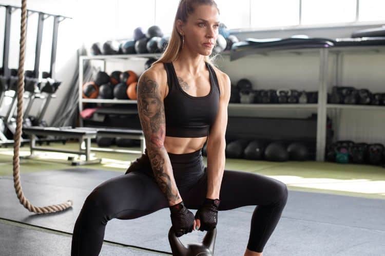 Woman performing burpees in a 45-minute advanced HIIT workout