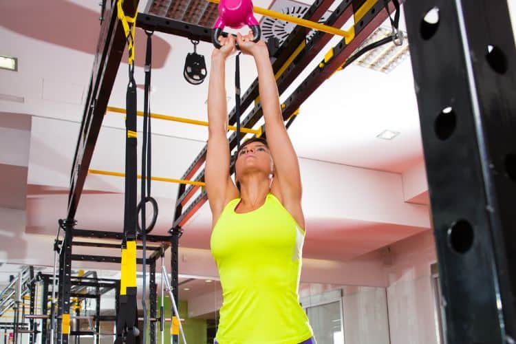 Woman performing kettlebell swings during a 45-minute functional workout