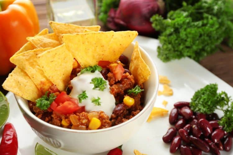 Homemade Mexican burrito bowl with rice, beans, chicken, and guacamole