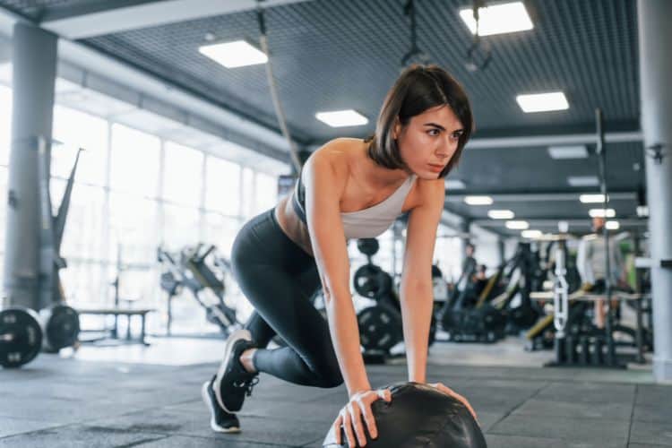Woman performing burpees during a 15 minute HIIT workout