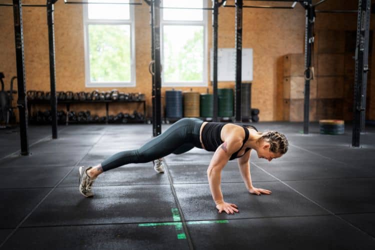 Woman performing burpees during a 20 minute full body cardio workout