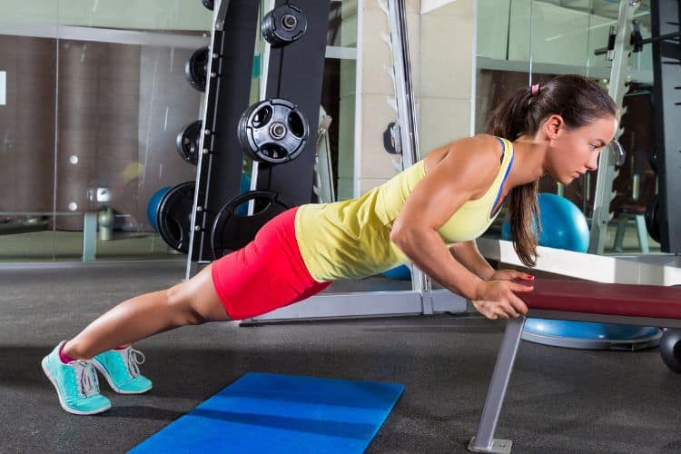 Woman performing push up full body superset workout for strength and cardio