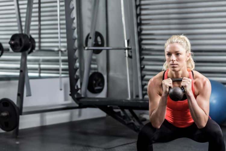 Woman doing burpees during a 20 minute HIIT workout