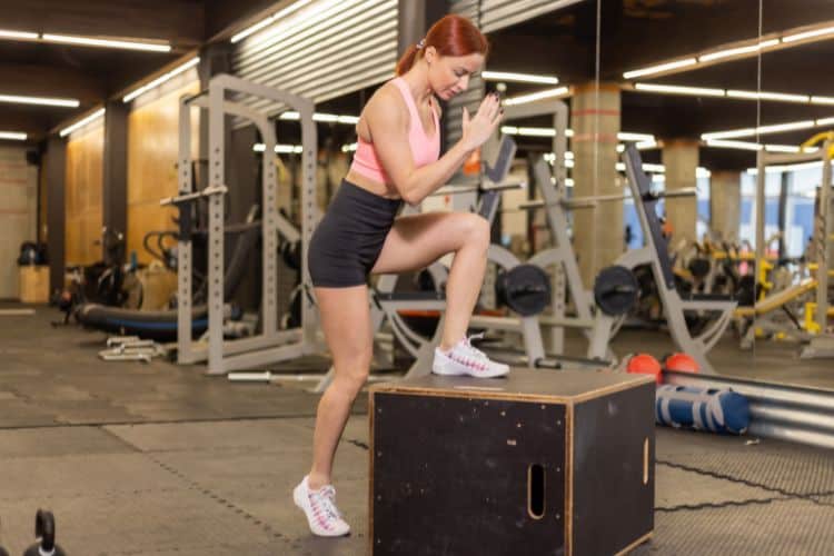 Woman performing jump squats during a 30 minute HIIT workout