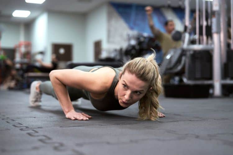 Woman performing burpees during a 45 minute full body HIIT cardio workout