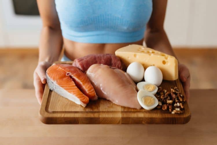 Importance of protein rich foods for women including eggs fish beans and nuts on a table