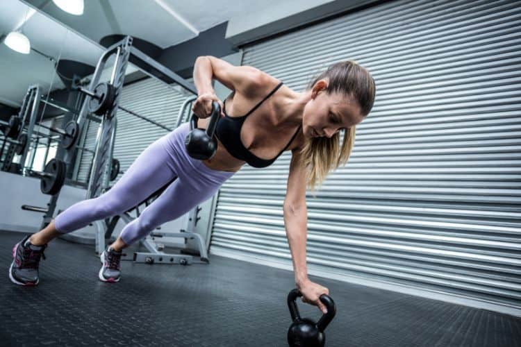 Woman performing kettlebell swings during a 10 minute full body HIIT workout