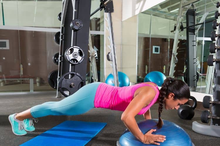 Woman performing push-ups as part of a 30-minute full body superset workout