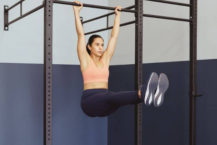 Beginner performing a pull-up bar in the gym during a 30-minute calisthenics workout
