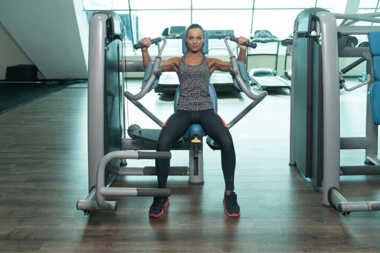 best machine chest workout with a woman using a chest press machine