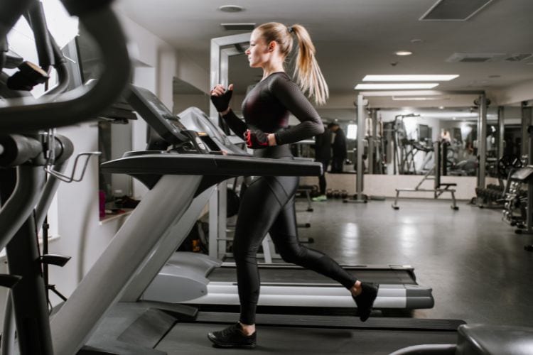 A woman performing treadmill workout during a 45-minute stress relief workout routine.
