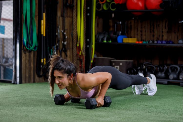 Woman demonstrating perfect burpee form during a 30-day workout fitness burpee challenge.